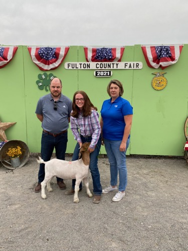 bank reps standing with Molly and her goat