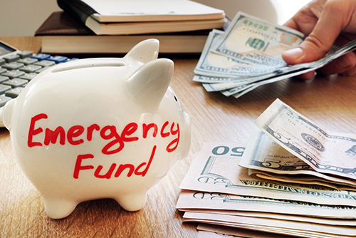 piggy bank with emergency funds written on it