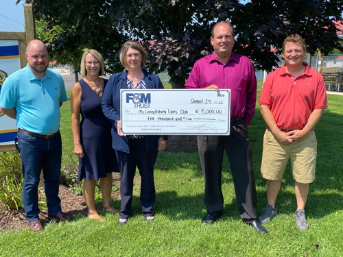 representatives from F&M and Lions Club pictured with donation check