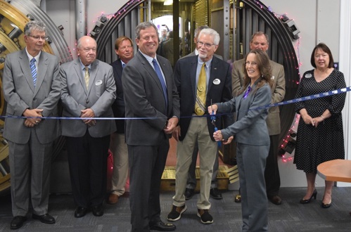 A group of people cutting a ribbon at a new bank location